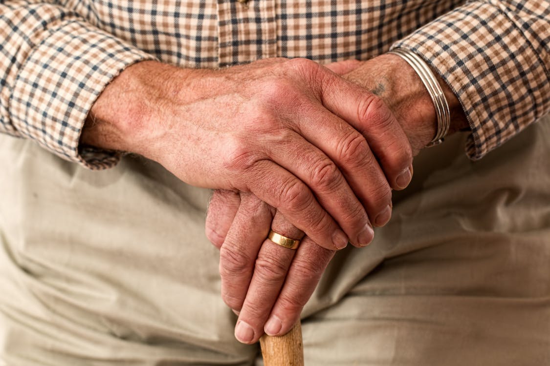 hands walking stick elderly old person