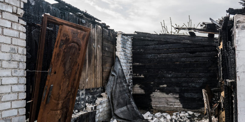 900 burnt out dwelling with charred walls and destruction